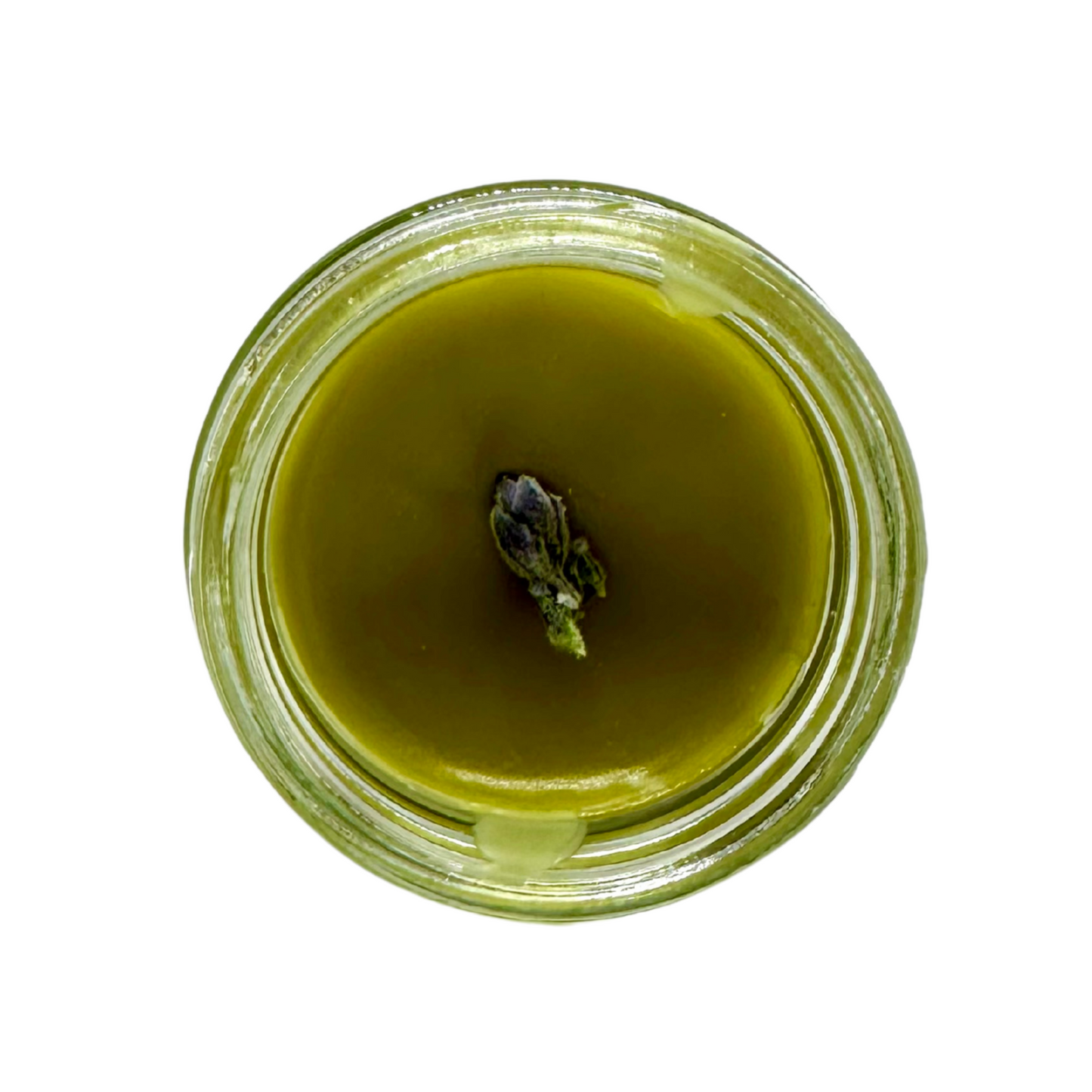 Overhead view of a glass jar with a green balm and purple plant material inside