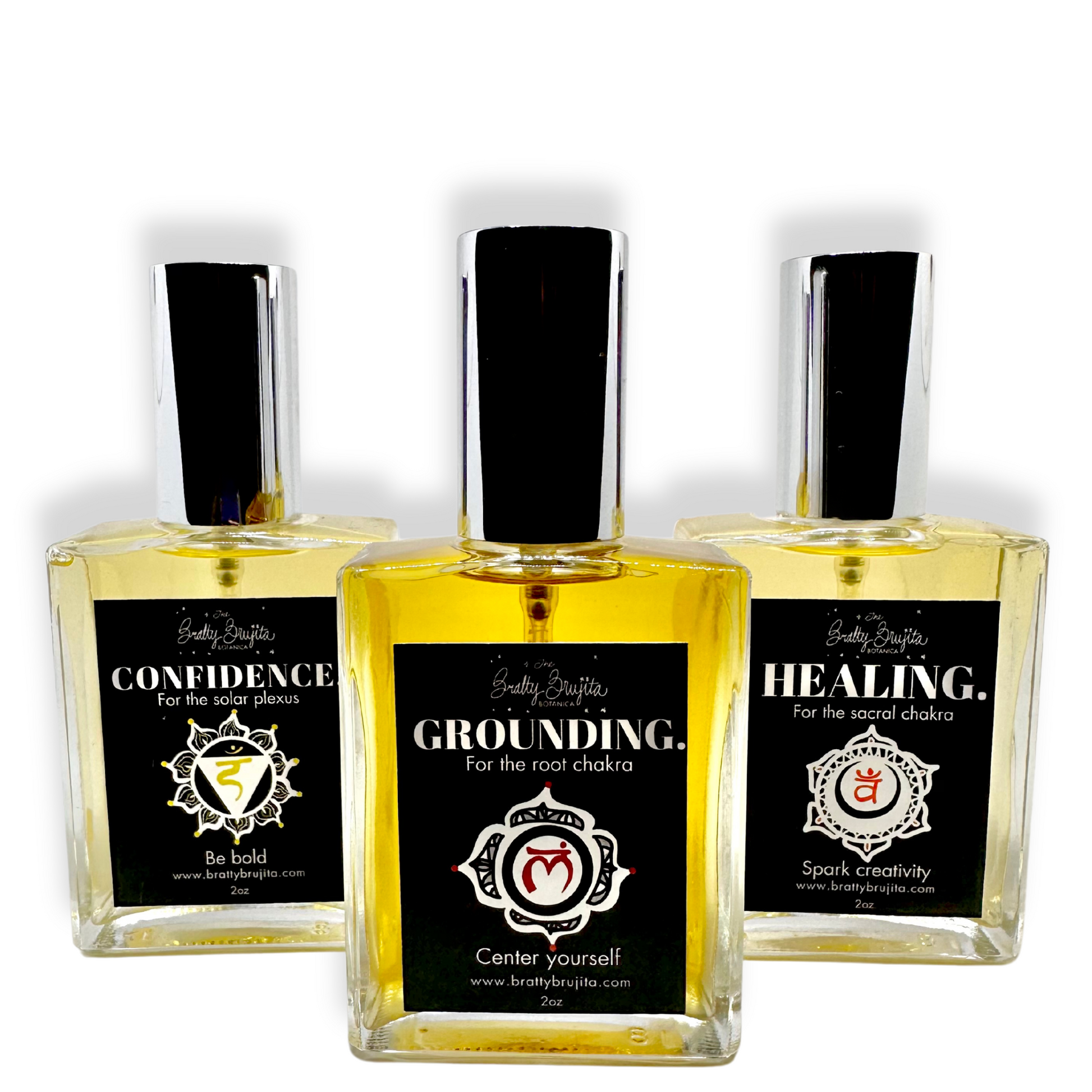 Three glass spray bottles against a white background each separately labeled: Confidence, Grounding, and Healing.