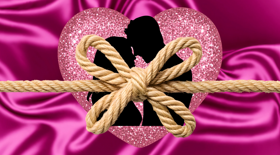 A silky hot pink background with a glittery light pink heart in the center with a silhouette of a man and a woman with a rope tied over them