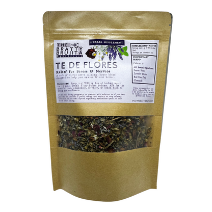 Packaging brown satchel of 'Te De Flores' herbal tea with a purple label and a visible window showing the dried floral tea and herbal leaves.